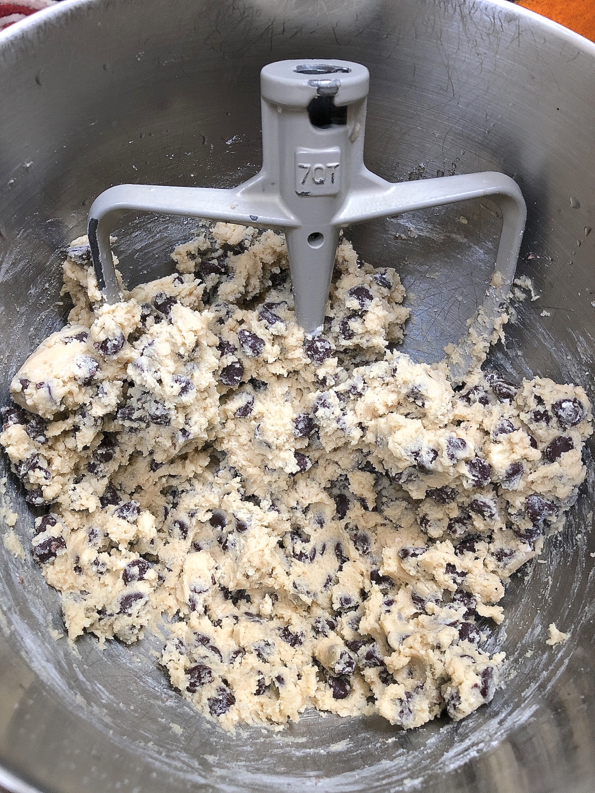Bowl of chocolate chip cookie dough, ready to scoop.