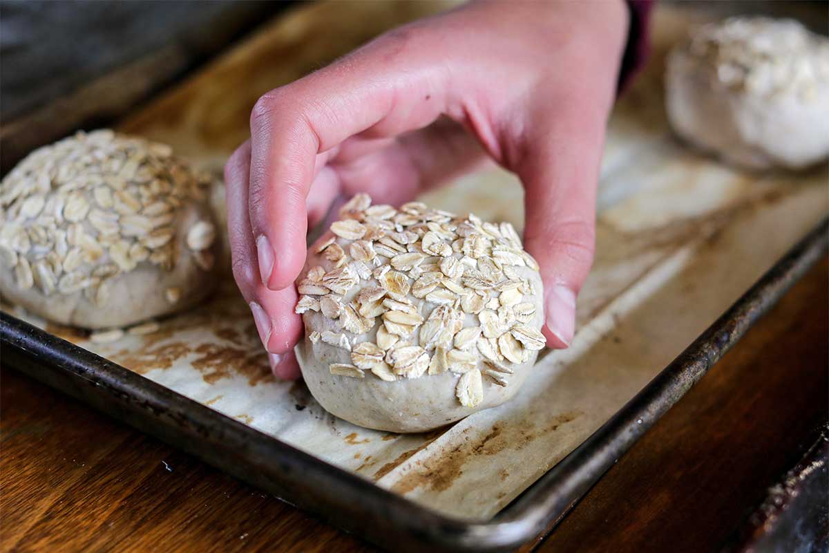 Unbaked roll, now covered with seeds