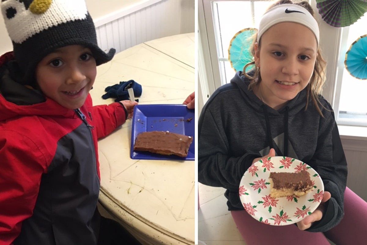 Two kids enjoying slices of birthday cake