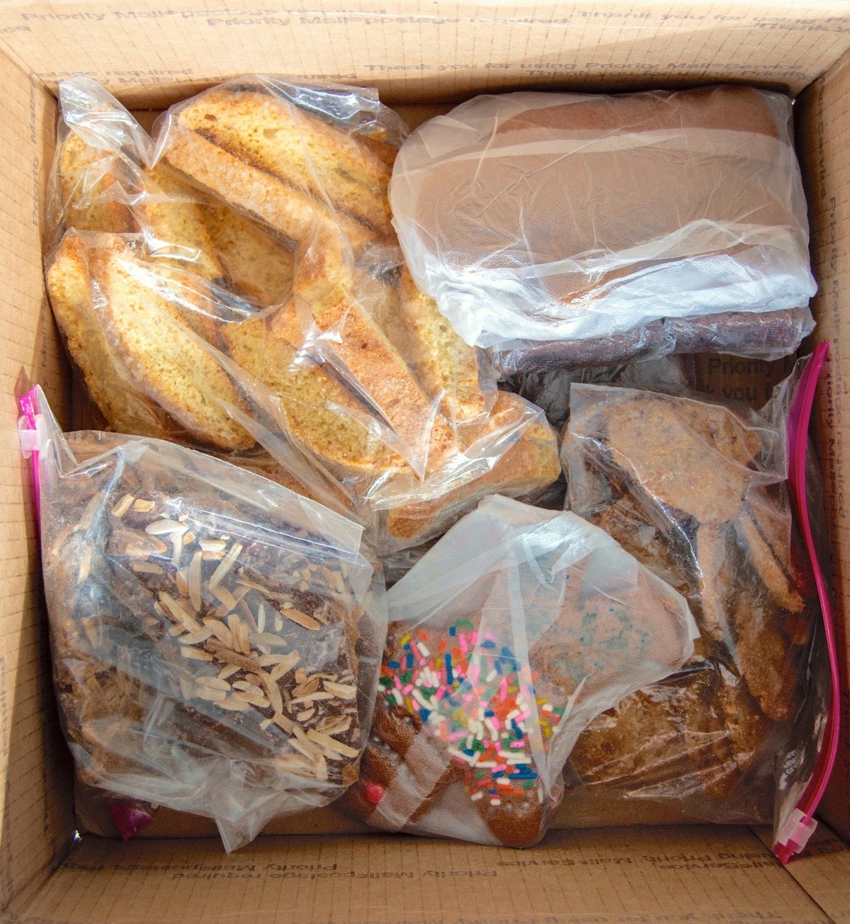 Shipping carton of baked treats being unwrapped after cross country trip.