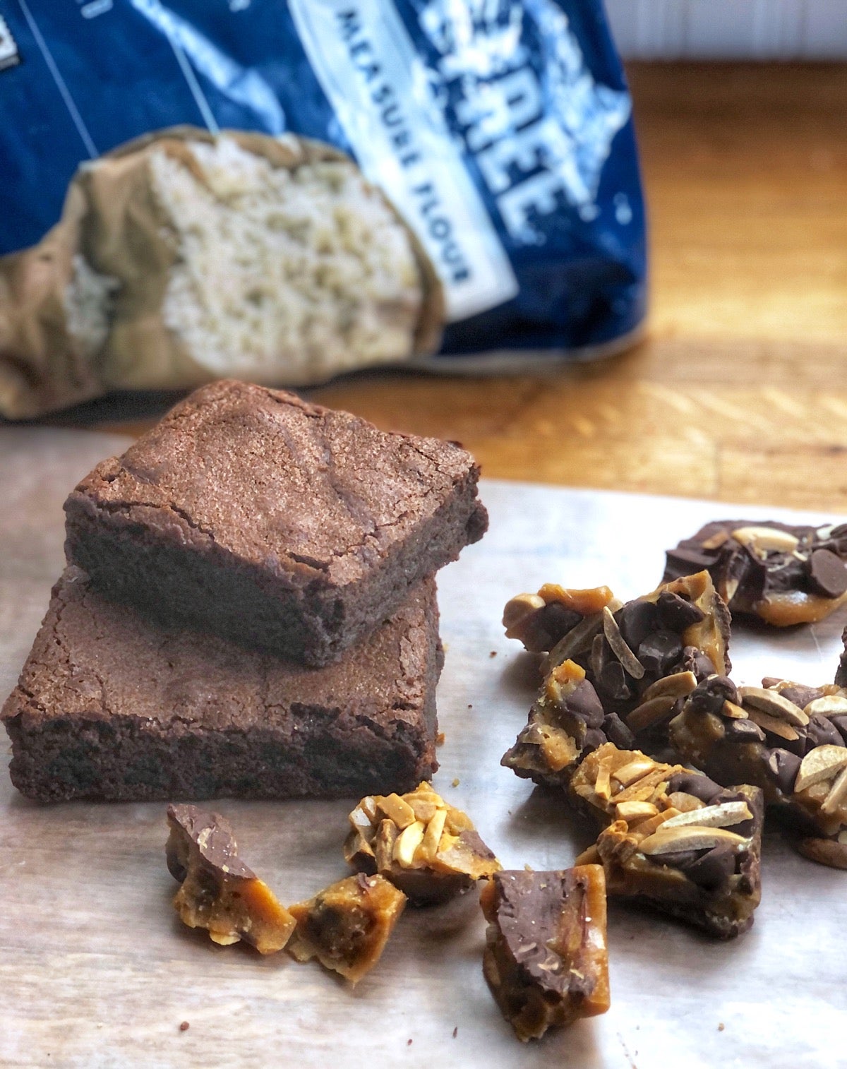 Gluten-free brownies and buttercrunch candy on a piece of parchment.