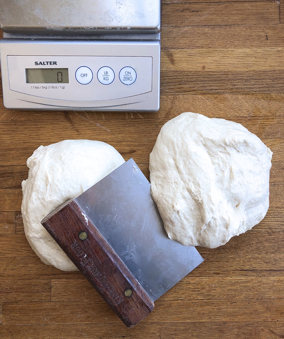 Batch of Hearth Bread dough cut in half using a baker's bench knife and scale.