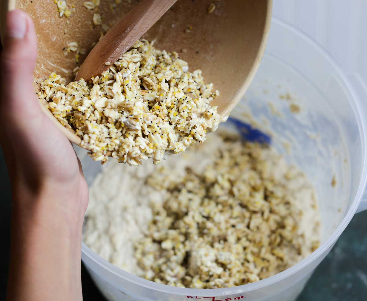 Soaker being added from mixing bowl to bread dough