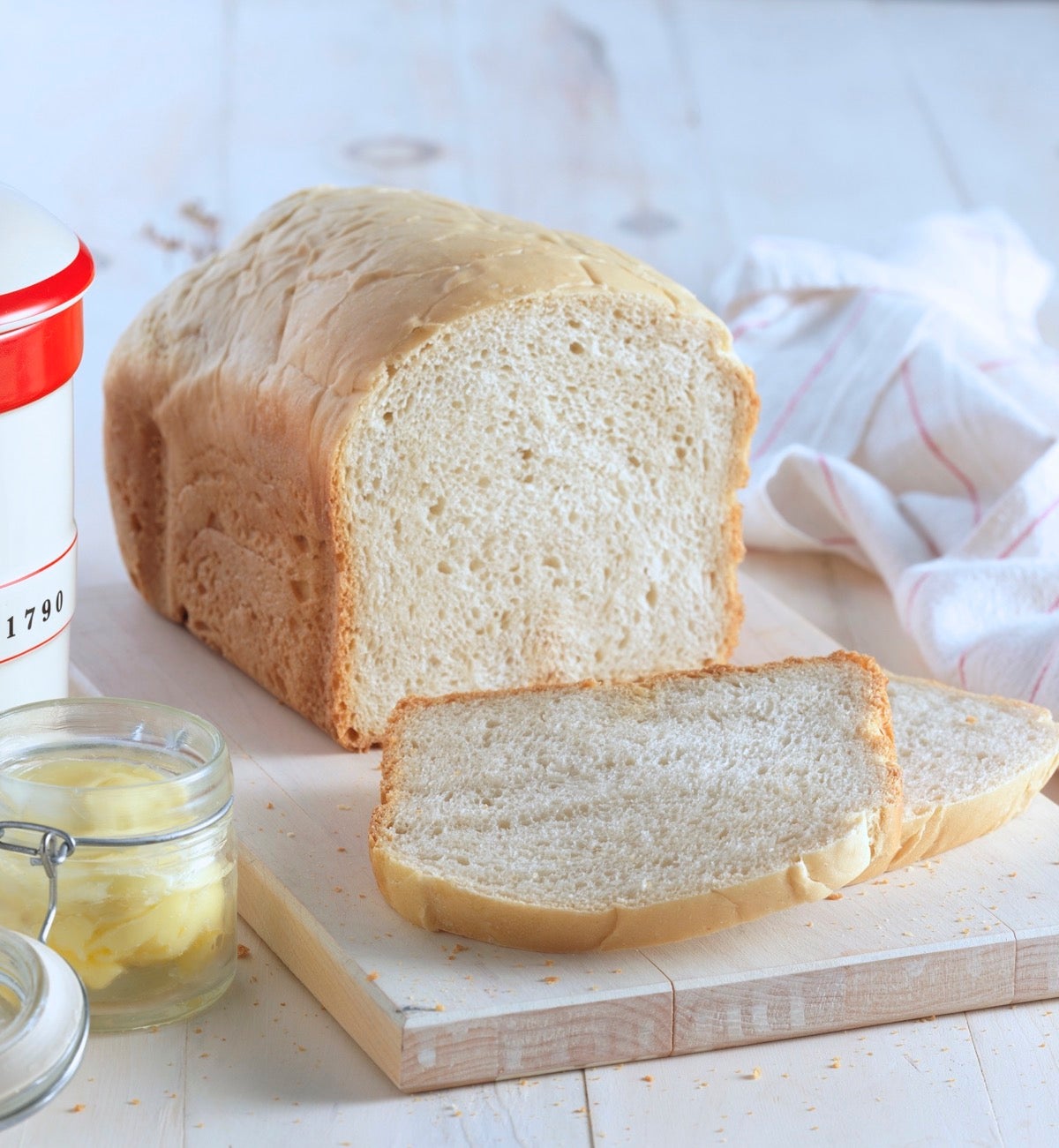 Loaf of bread machine sourdough bread sliced on a cutting board