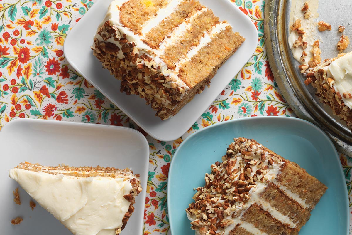 A few slices of triple layer carrot cake on plates