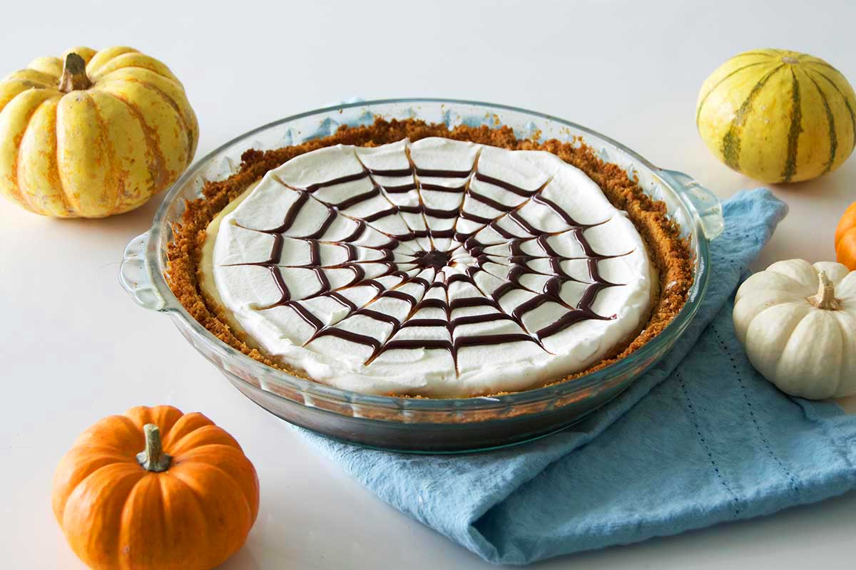 Finished cheesecake surrounded by mini pumpkins