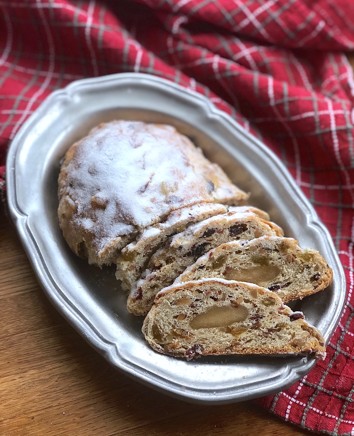 Christmas Stollen sliced on a pewter plate, ready to serve.