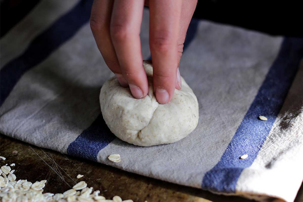 Placing an unbaked roll on damp towel