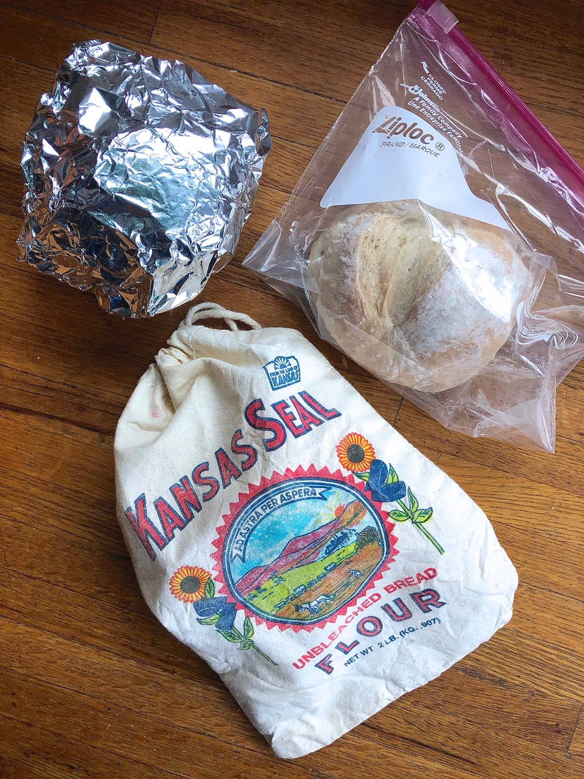 Small round loaves stored in zip-top bag, cloth bag, and foil.