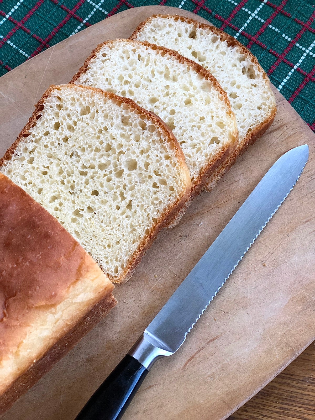 Loaf of English Muffin Toasting Bread on a cutting board, sliced.