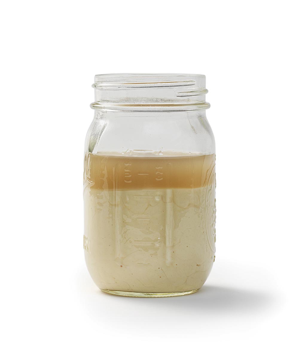A mason jar full of unfed starter