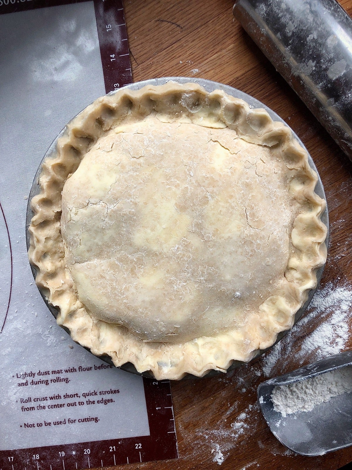 Apple pie ready to be topped with coarse sugar, slashed, and put into the oven to bake.