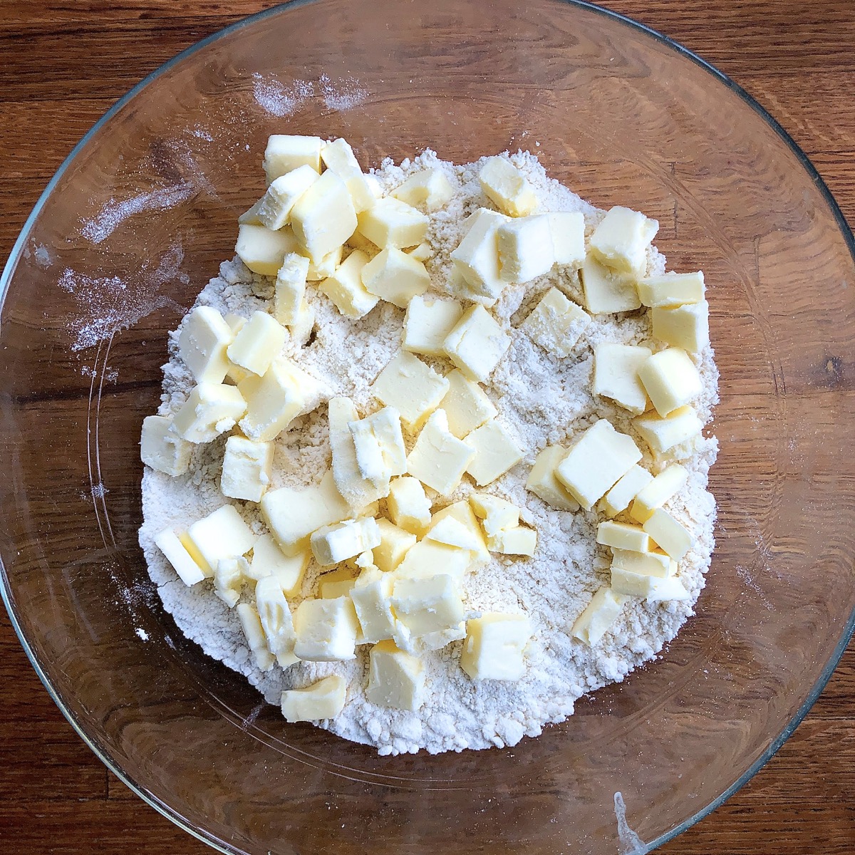 Cubes of cold butter atop a sandy textured mixture of flour, salt, and shortening.