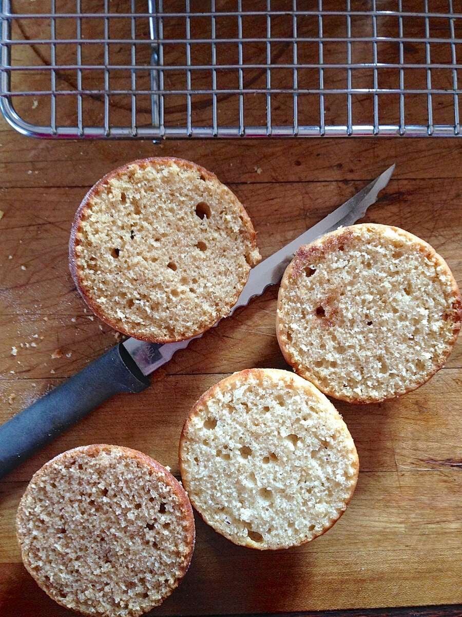 Doughnut muffins made with whole wheat flour, cut in half crosswise to show the color of their interior.