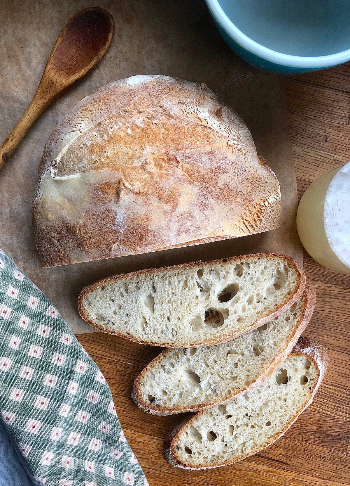 Bread made with yeast water starter, cut into slices on a wooden board.