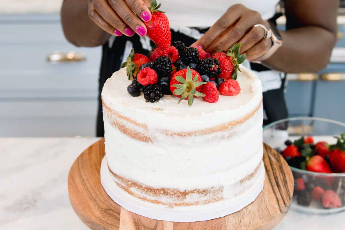 Zainab topping cake with berries