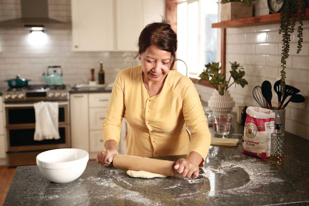 Ha rolling out dough in the kitchen