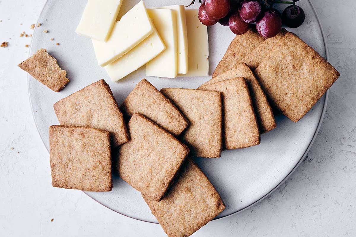 Rye shortbread on a plate with cheese and grapes
