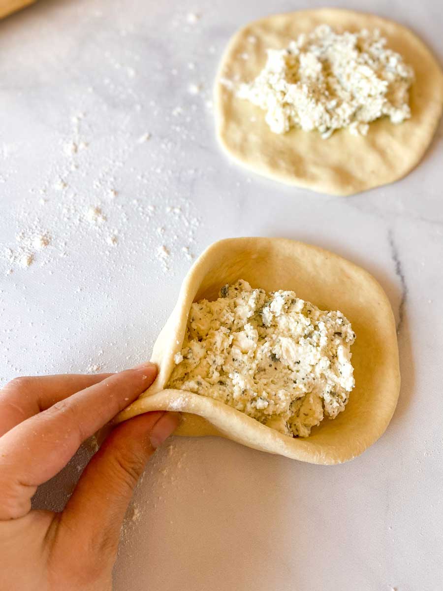 Shaping cheese Fatayer by pinching ends together