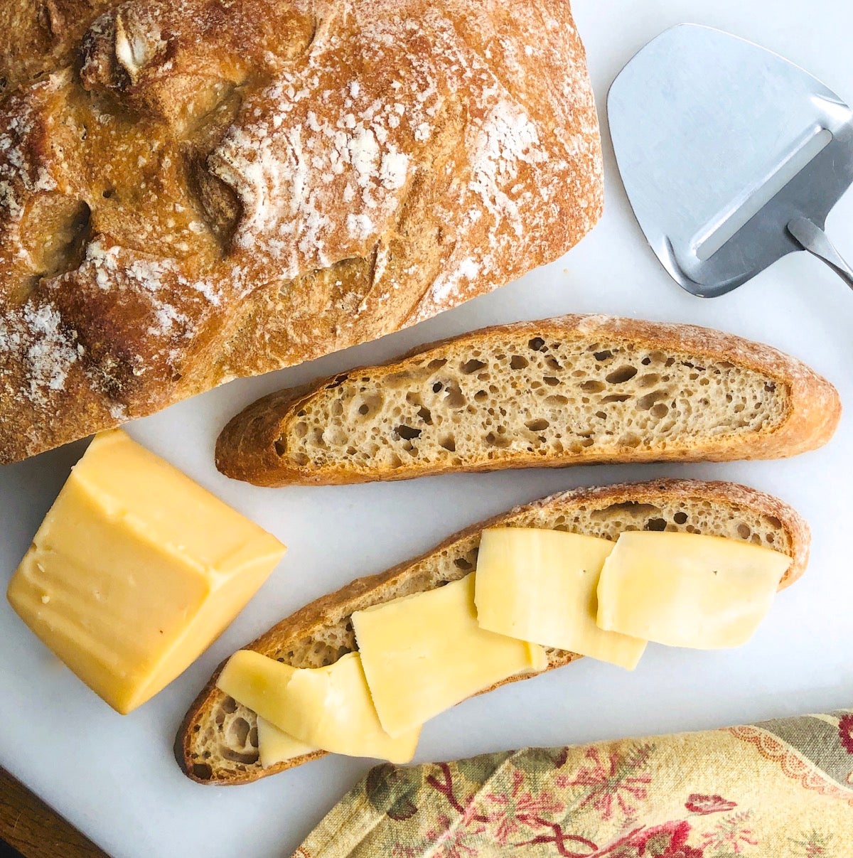 Do-Nothing Sourdough Bread sliced thin and topped with smoked cheese.