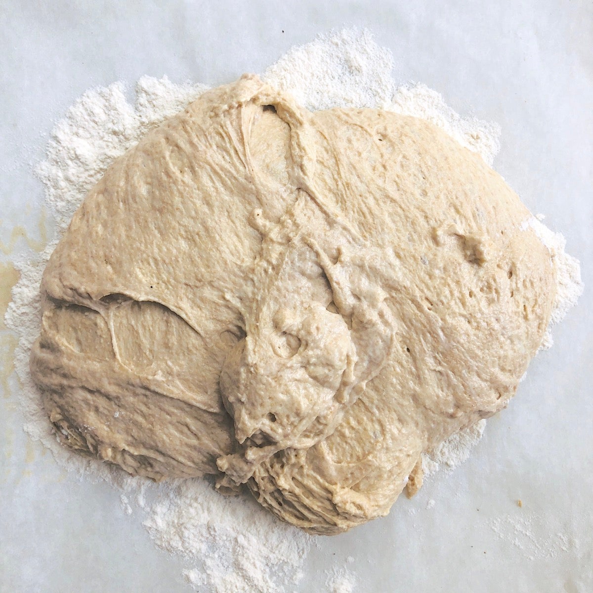 Sticky, slack dough turned out onto a floured work surface.