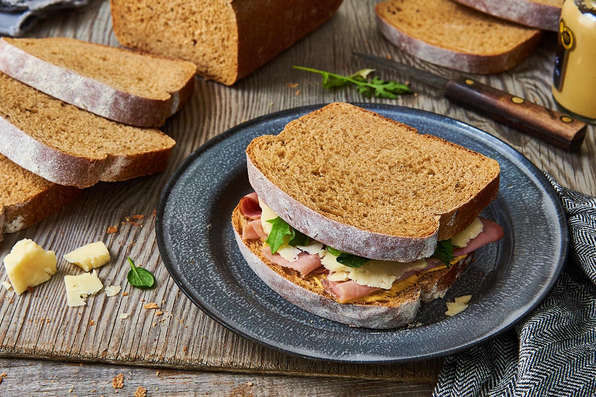 A loaf of rye sandwich bread cut into slices and made into a sandwich