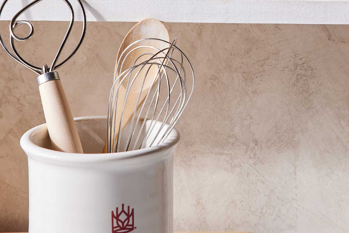 Dough whisk and regular whisk in spoon holder