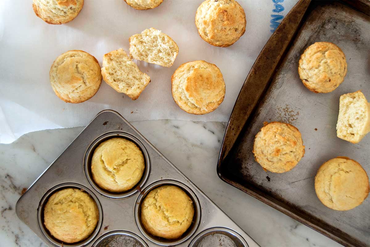 Muffins on trays and kitchen counter