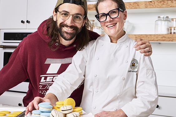 Two employee-owners with macarons