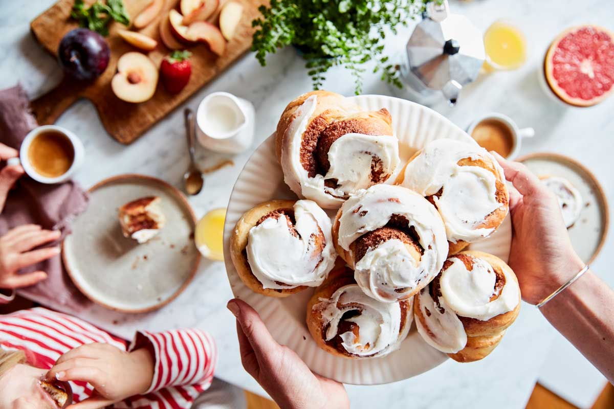 Holding tray of cinnamon rolls