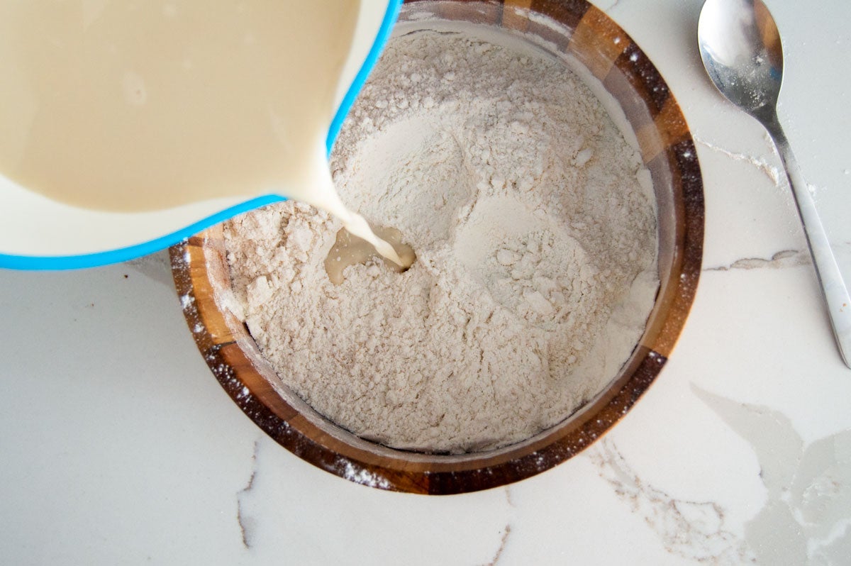 Drizzling milk into dry ingredients 