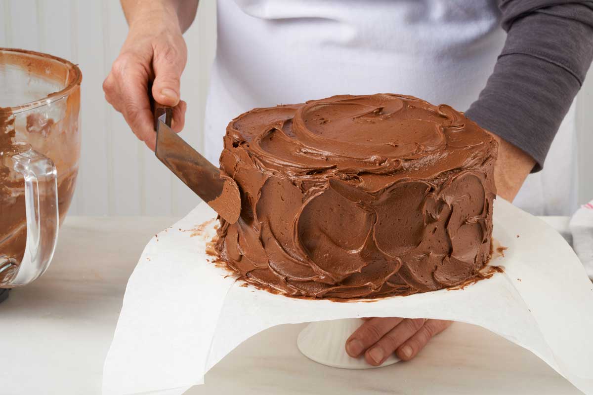 Hands frosting cake 