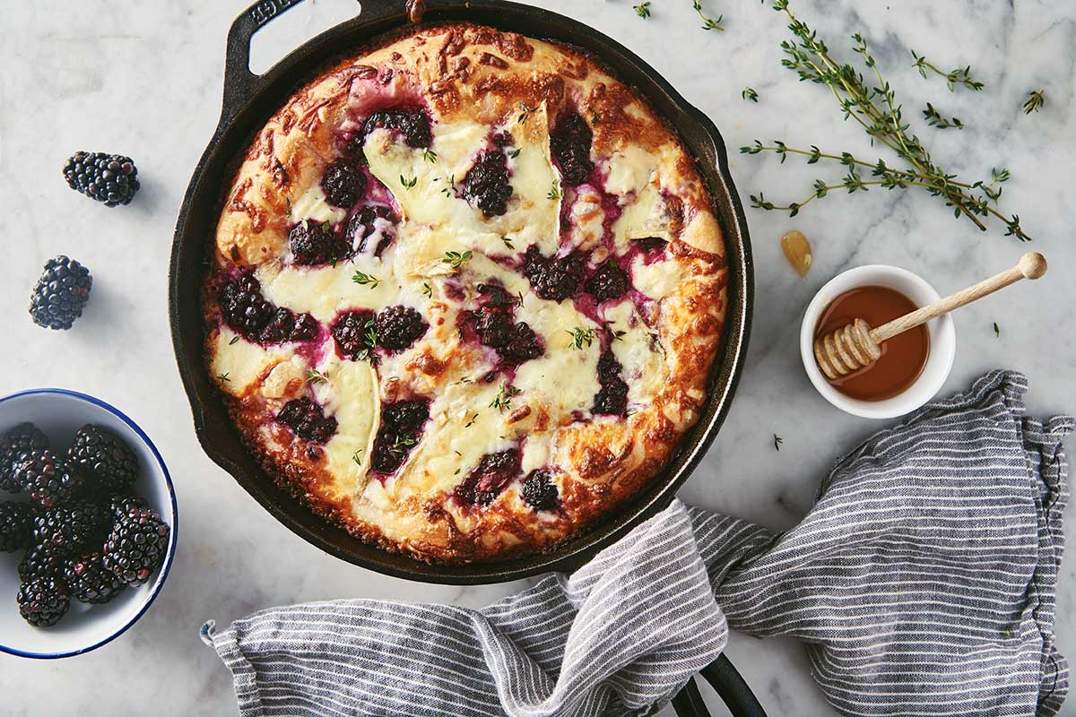 Crispy Cheesy Pan Pizza topped with honey, ricotta, blackberries, and brie