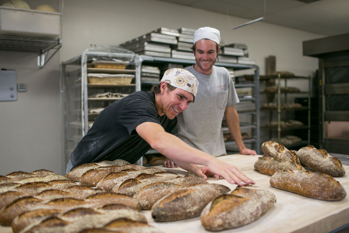 Prager Brothers with loaves of bread in their bakery kitchen