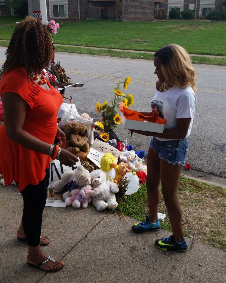 Rose with young wife at Michael Brown's memorial