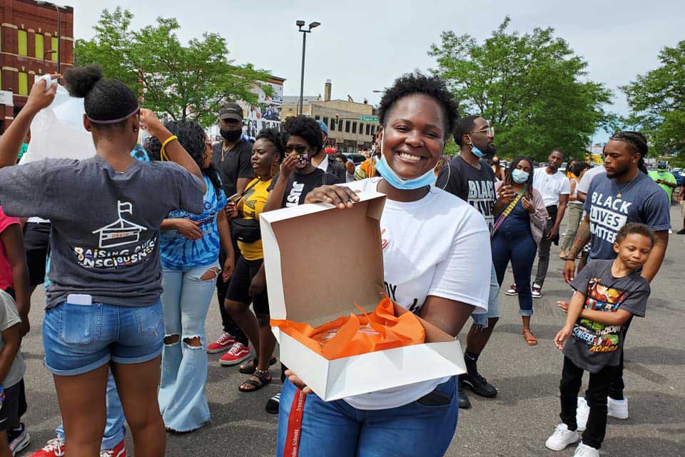 Woman holding sweet potato pie in protest