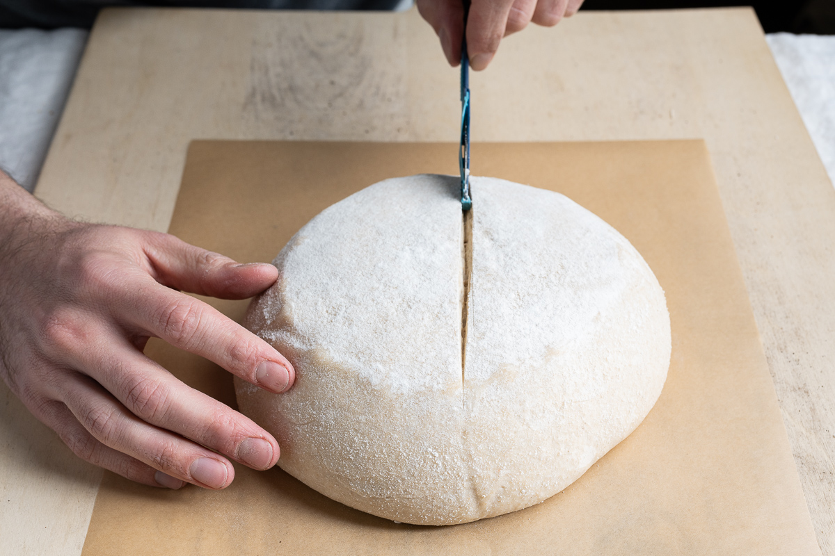 Scoring bread dough at a straight on angle
