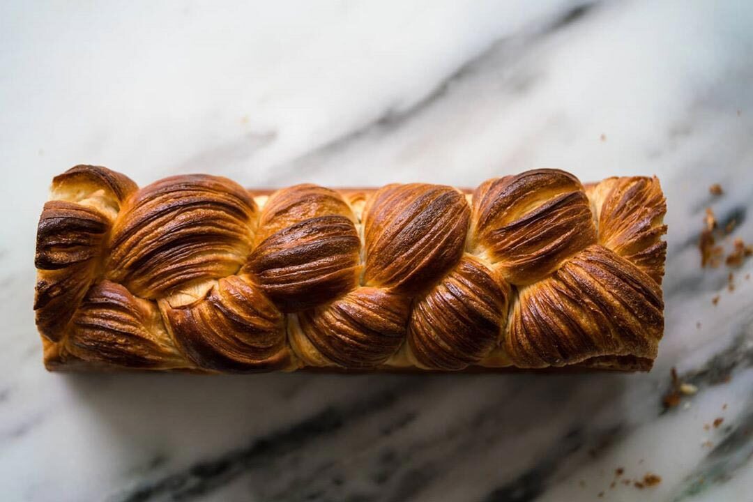 A loaf of laminated milk bread beautifully baked in a three-strand braid