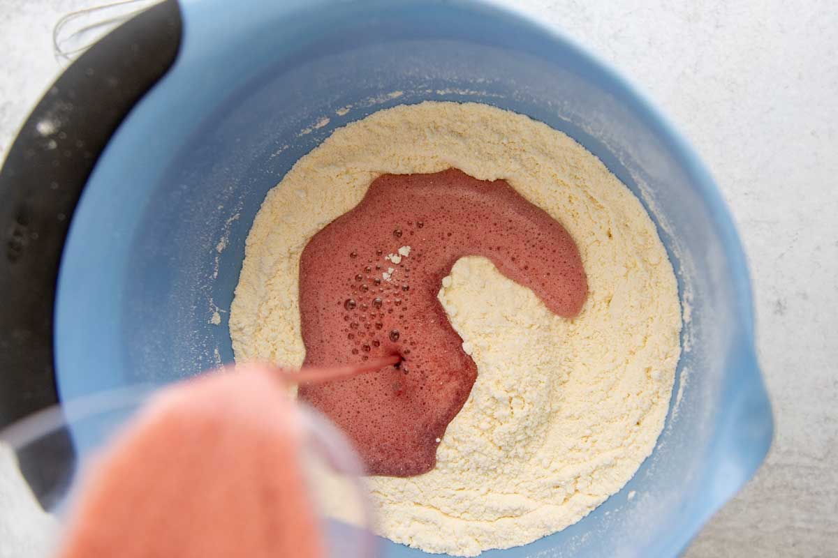 Beet-dyed eggs being poured into try ingredients 