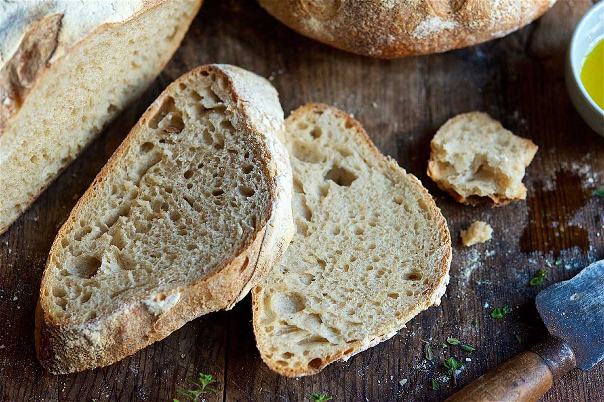 Two slices of sourdough on wooden cutting board