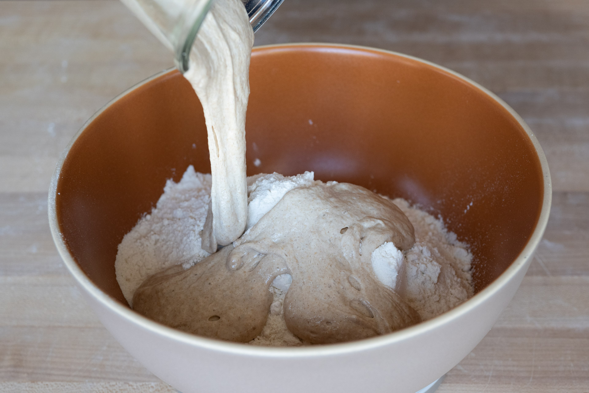 Mixing sourdough starter into flour