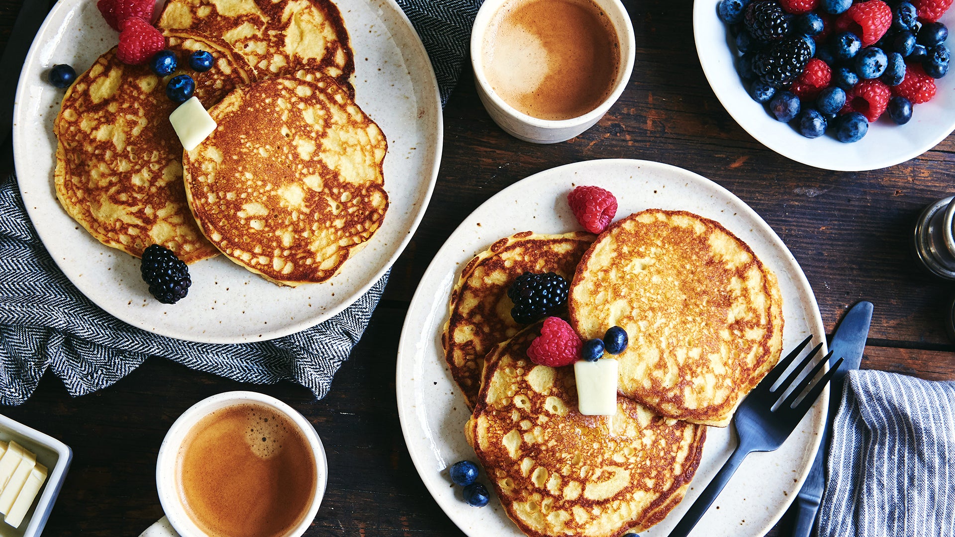 Pancakes and berries on a wood table