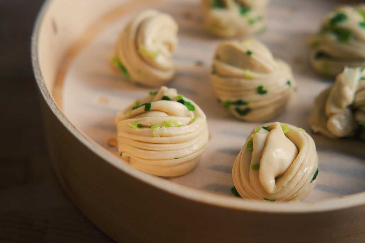 Un-steamed buns in bamboo basket