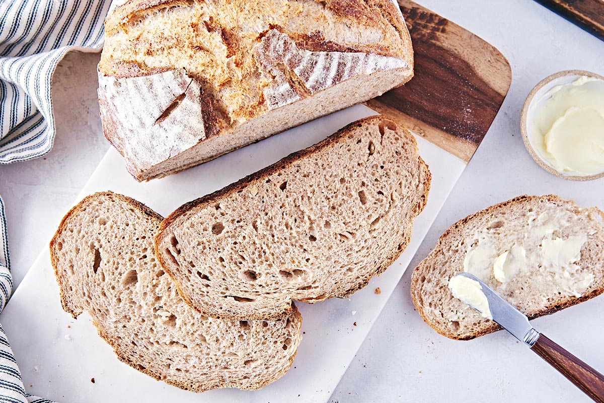 A round loaf of rye bread cut into slices