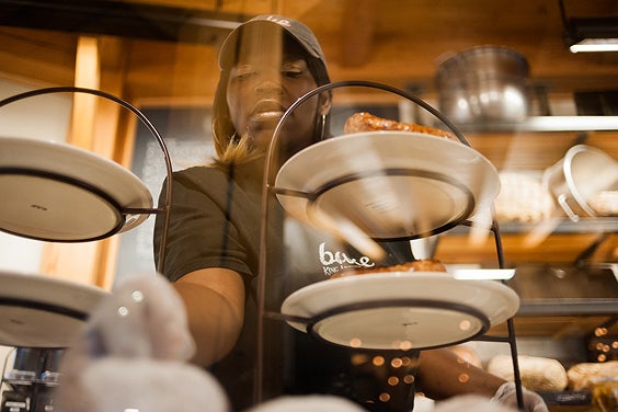 A café worker serving pastries