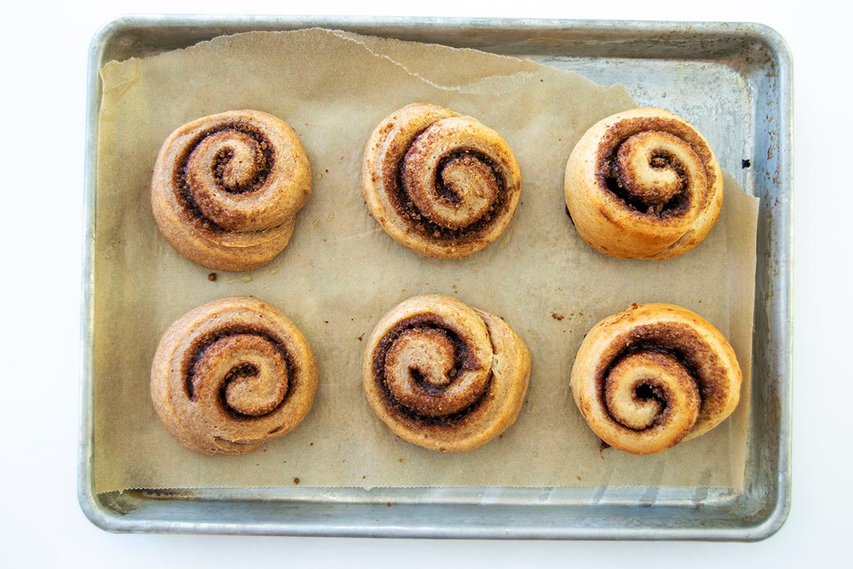 Whole wheat and rye cinnamon rolls on baking sheet