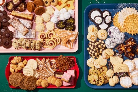 Three platters with many different varieties of cookies