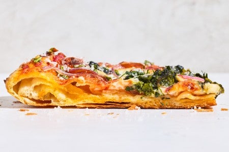Sideview of a slice of Flaky Puff Crust Pizza