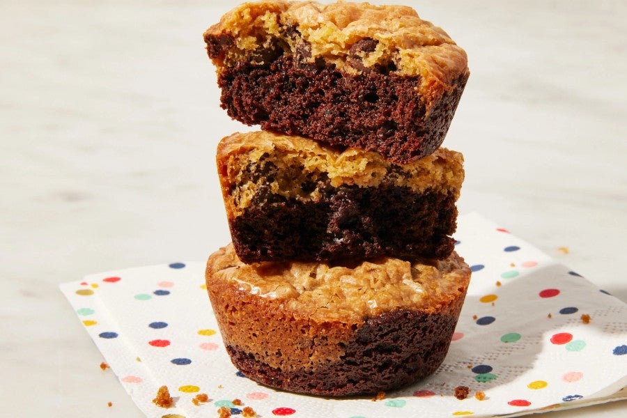 Stack of three brownie cookies on a colorful napkin. 