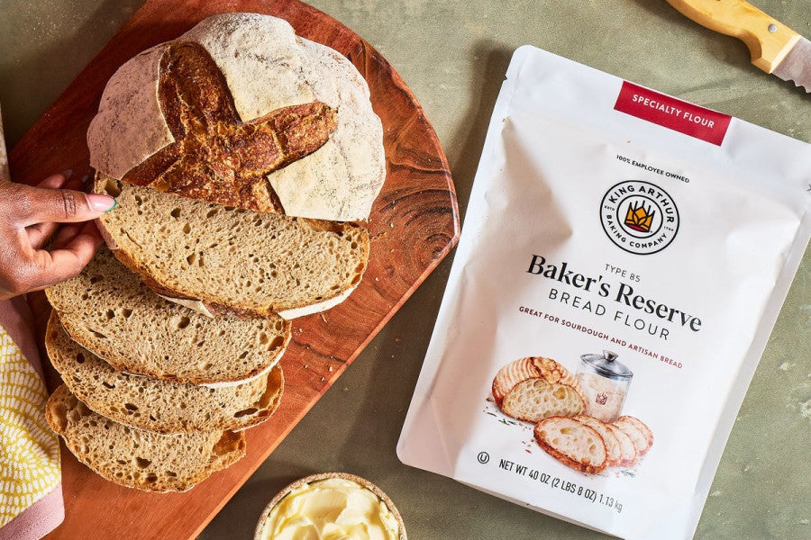 Bag of Baker's Reserve Bread Flour next to a loaf of artisan bread